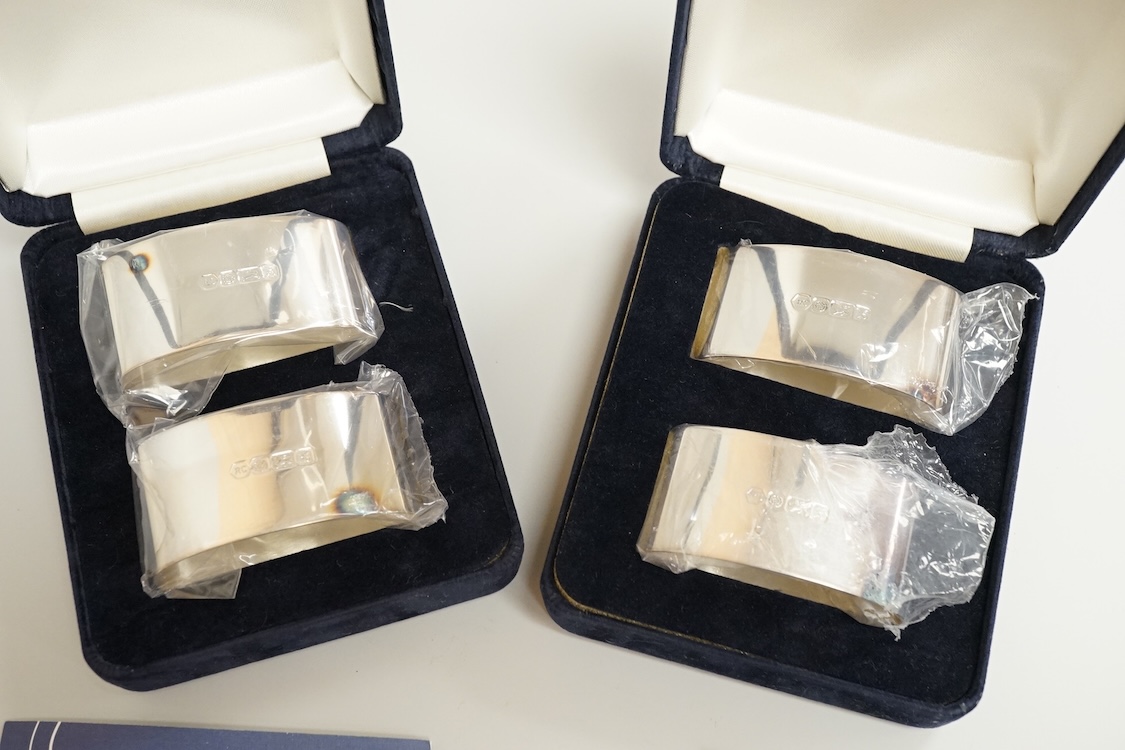 Two boxed pairs of Elizabeth II silver napkin rings by Carr's of Sheffield, Sheffield, 1997.